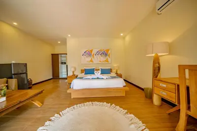 a bedroom with a bed and a living room at Villa Domino - *NEW* Luxurious 2BR w/ Pool @Central Seminyak in Seminyak