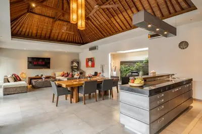 a kitchen and dining room with a table and chairs at Villa 500m2 with 14m Pool, BBQ, Pinball - Seminyak in Seminyak