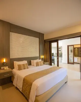 a bedroom with a large bed and a large window at Luxotic Private Villa and Resort in Nusa Dua