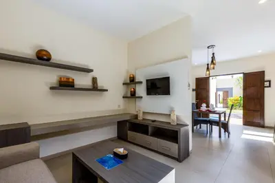 a living room with a couch and a table at Luxotic Private Villa and Resort in Nusa Dua