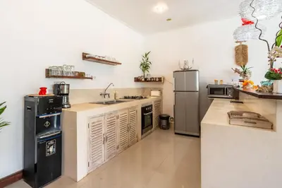 a large kitchen with a sink and a refrigerator at Villa Ricci Seminyak in Kerobokan