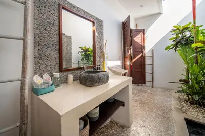 a bathroom with a sink and a mirror at Villa Ricci Seminyak in Kerobokan
