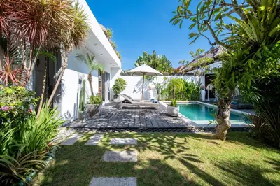 a backyard with a swimming pool and a villa at Villa Ricci Seminyak in Kerobokan