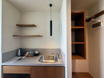 a kitchen with a sink and a counter top at The Fields Hotel and Apartment in Seminyak