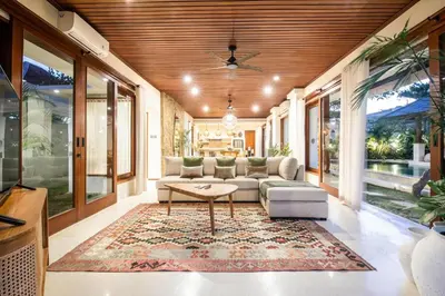 a living room with a couch and a table at Colonial-style 4BR Villa, 400m to Canggu Beach in Canggu