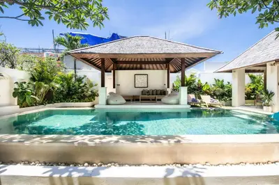 a swimming pool in a villa with a gazebo at Colonial-style 4BR Villa, 400m to Canggu Beach in Canggu