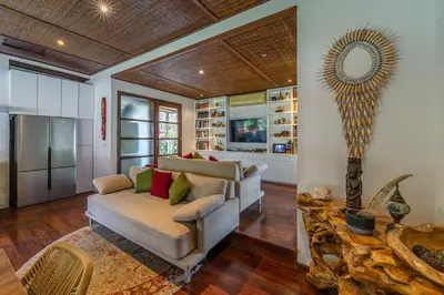 a living room with a couch and a mirror at Villa Claudia - Chic 3BR Family Villa with Pool & Play near Seminyak in Kerobokan