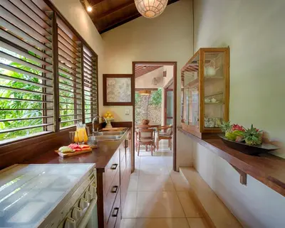 a kitchen with a counter and a dining room at Villa Kubu Seminyak in Seminyak