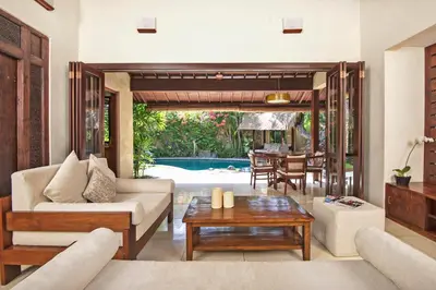 a living room with a couch and a table at Villa Kubu Seminyak in Seminyak