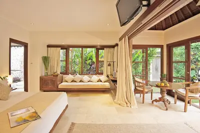 a living room with a couch and a table at Villa Kubu Seminyak in Seminyak