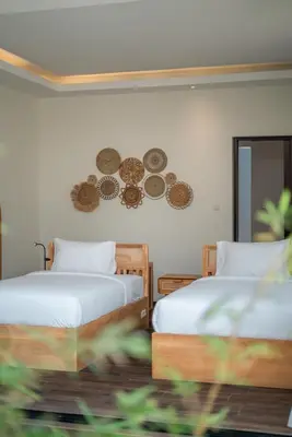 a bedroom with two beds and a mirror at Villa Selikur 1 - Spacious 3BR Villa in Seminyak! Perfect location! in Seminyak