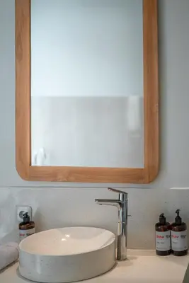 a bathroom sink with a mirror above a white sink at Villa Selikur 1 - Spacious 3BR Villa in Seminyak! Perfect location! in Seminyak