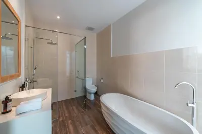 a bathroom with a tub and a sink and a toilet at Villa Selikur 1 - Spacious 3BR Villa in Seminyak! Perfect location! in Seminyak