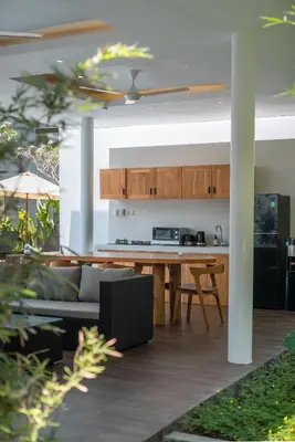 a kitchen and living room with a couch and a table at Villa Selikur 2 - Brand New! Spacious 3BR Villa in Seminyak in Seminyak