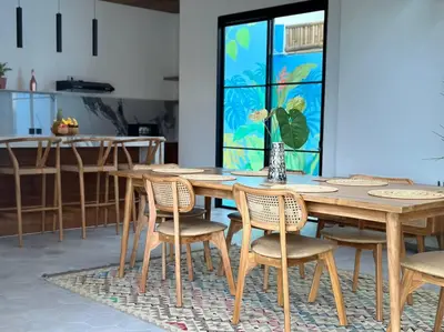 a wooden table and chairs in a room at Villa Solaris Umalas by Santi Management in Kerobokan