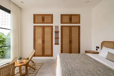 a bedroom with white walls and a bed and a window at Villa Solaris Umalas by Santi Management in Kerobokan