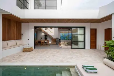 a living room with a pool in a house at Villa Solaris Umalas by Santi Management in Kerobokan
