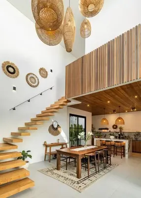 a dining room with a table and a staircase at Villa Anita Umalas by Santi Management in Kerobokan