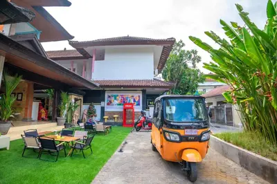 an orange scooter parked in front of a house at BS Home in Kuta