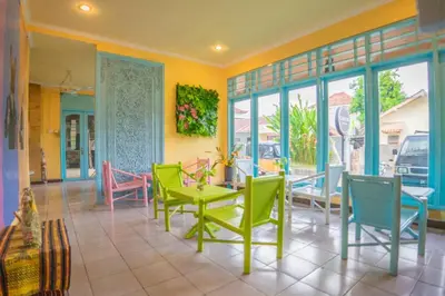 a dining room with colorful chairs and a table at BS Home in Kuta