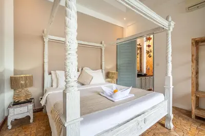 a bedroom with a white canopy bed with a bowl on it at Villa Vaiana Seminyak in Seminyak