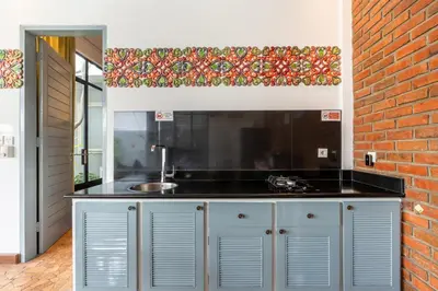 a kitchen with a sink and a brick wall at Villa Vaiana Seminyak in Seminyak