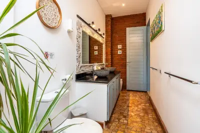 a bathroom with a sink and a mirror at Villa Vaiana Seminyak in Seminyak