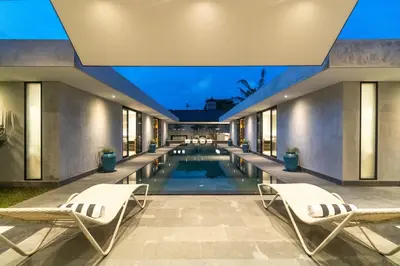 a swimming pool in the middle of a house at Villa KALOOKA, a vacation in paradise. in Seminyak