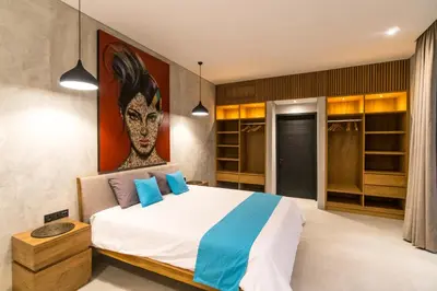 a bedroom with a large bed with blue pillows at Villa KALOOKA, a vacation in paradise. in Seminyak