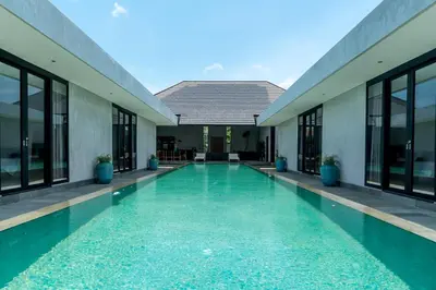 a swimming pool in the middle of a building at Villa KALOOKA, a vacation in paradise. in Seminyak