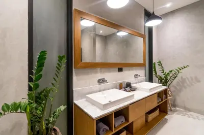 a bathroom with two sinks and a mirror at Villa KALOOKA, a vacation in paradise. in Seminyak