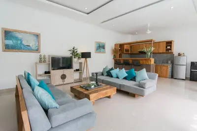 a living room with two couches and a coffee table at Stylish Three Bedroom Villa Near Atlas Beach Club & Beach. in Canggu