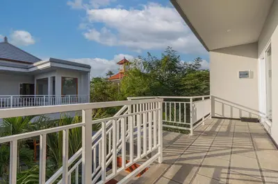 a balcony of a house with a white railing at Villa Rose 1 Sanur in Sanur