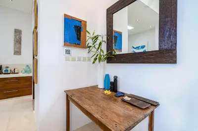 a bathroom with a wooden table and a mirror at Villa Celine 2 chambres piscine Seminyak BALI in Seminyak
