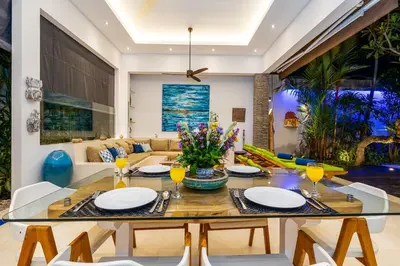 a dining room with a table and a couch at Villa Celine 2 chambres piscine Seminyak BALI in Seminyak