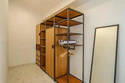 a closet with wooden shelves and a mirror at Villa Marina Seminyak in Seminyak