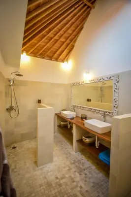 a bathroom with two sinks and a large mirror at Villa Mana Tea 2 bedrooms & pool Seminyak in Seminyak