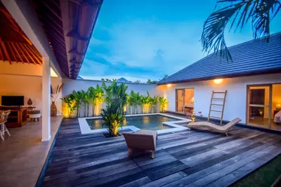 a backyard with a pool and a house at Villa Mana Tea 2 bedrooms & pool Seminyak in Seminyak