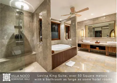 a large bathroom with a tub and a shower at Noco Luxury Villa Seminyak in Seminyak