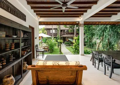 a patio with a table and chairs and a ceiling fan at Nativ Living Villa Legian 6BR Villa 16px Big Group Walk to 66 Beach in Seminyak