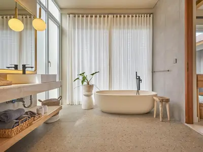 a bathroom with a tub and a large window at Luna Ola Villa Berawa in Canggu
