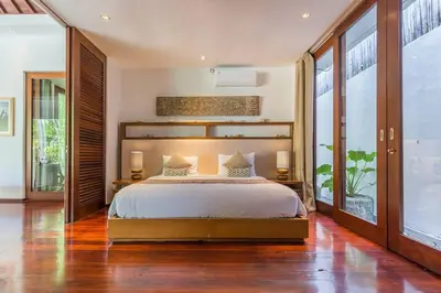 a bedroom with a bed and a large window at Eshara 1 our Tropical & luxury 3BR Villa 450m from beach in Seminyak