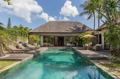 a swimming pool in front of a villa at Eshara 1 our Tropical & luxury 3BR Villa 450m from beach in Seminyak