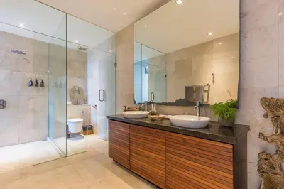 a bathroom with two sinks and a shower at Eshara 3 our Peaceful 3BR Pool Villa close to Oberoi Beach in Seminyak