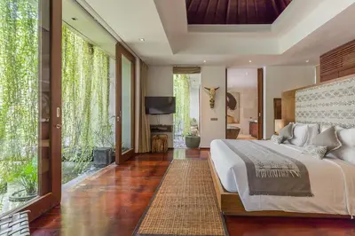 a bedroom with a large bed and large windows at Eshara 21 our Luxury 5BR Villa Escape and huge pool Oberoi Beach in Seminyak