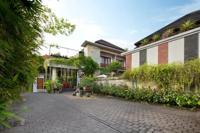 a courtyard of a house with trees and plants at Jineswari Kuta by Kamara in Kuta