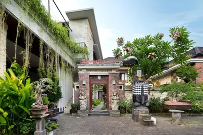 a courtyard of a building with plants on the side at Jineswari Kuta by Kamara in Kuta
