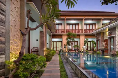 an exterior view of a resort with a swimming pool at Jineswari Kuta by Kamara in Kuta