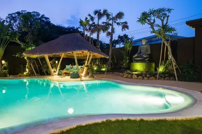 a swimming pool at night with a gazebo at Villa Lio - Tropical Escape in Canggu in Canggu