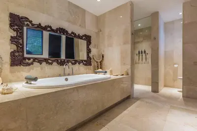 a large bathroom with a tub and a window at Eshara 123 in Oberoi our 8 BR Villa with 3 Pool close to Beach in Seminyak